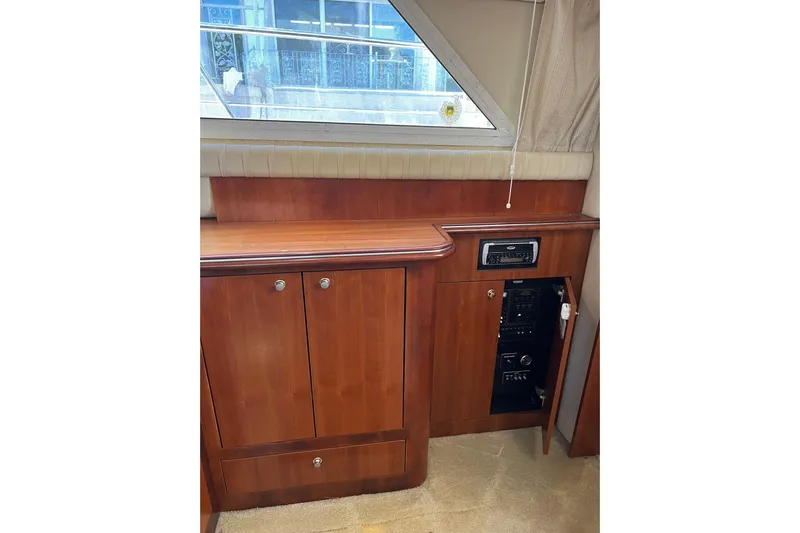 Quick X Yacht Photos Pics 2004 Cruisers Yachts 3750 Motoryacht interior with wooden cabinetry and audio system.