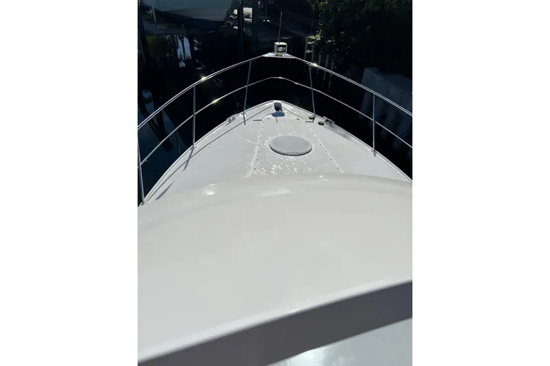 Quick X Yacht Photos Pics 2004 Cruisers Yachts 3750 Motoryacht bow view with railing and hatch.