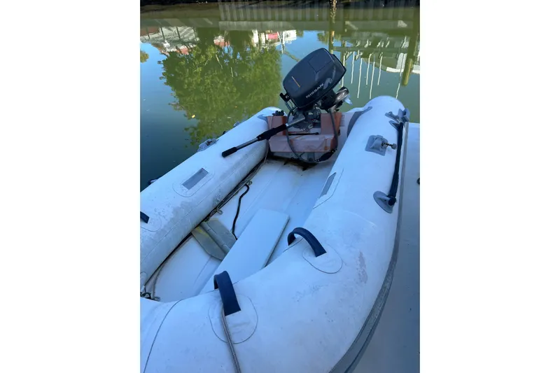 Quick X Yacht Photos Pics Inflatable boat with motor on water, near 2004 Cruisers Yachts 3750 Motoryacht.