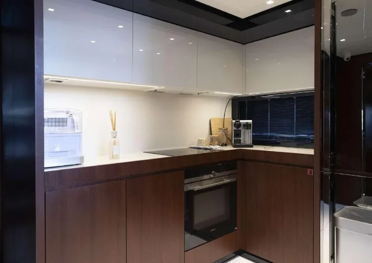  Yacht Photos Pics Modern kitchen interior on 2021 Riva 66' Ribelle yacht, featuring sleek cabinetry and appliances.