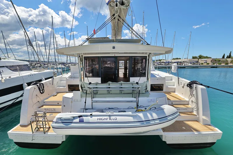 Breeze Yacht Photos Pics 2025 Bali 4.4 catamaran docked in marina, featuring spacious deck and inflatable dinghy.
