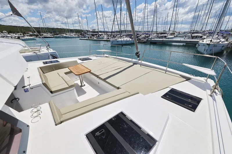 Breeze Yacht Photos Pics Luxurious Bali 4.4 yacht deck with seating, table, and marina view, 2025 model.