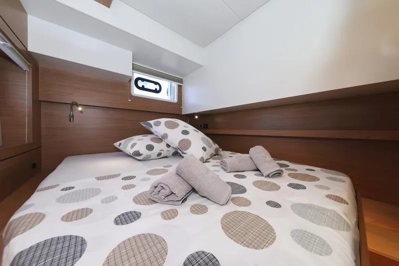 Breeze Yacht Photos Pics Cozy cabin bedroom in 2025 Bali 4.4 yacht with polka dot bedding and rolled towels.