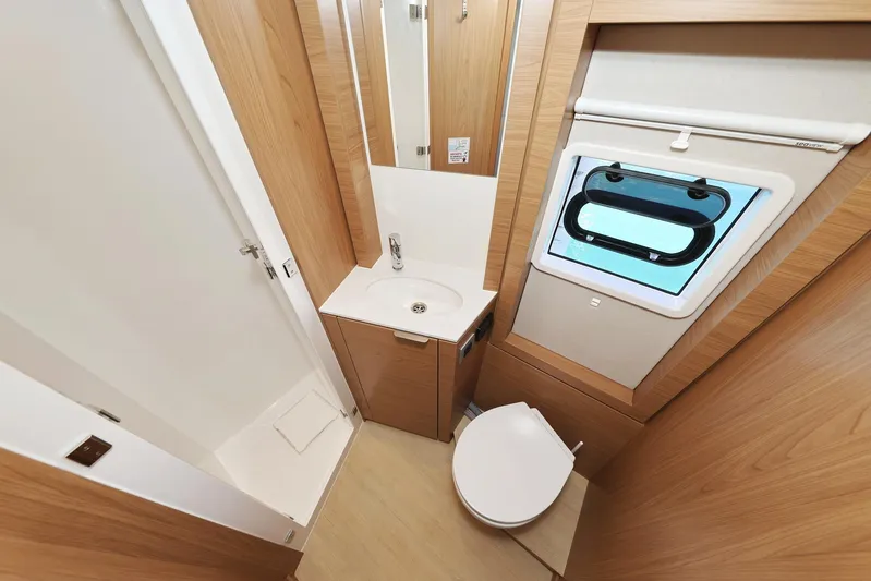 Breeze Yacht Photos Pics Compact bathroom in 2025 Bali 4.4 yacht with shower, sink, and window.