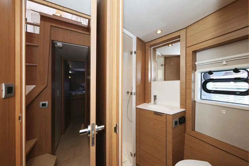 Breeze Yacht Photos Pics Modern yacht interior with wooden finish, featuring a compact bathroom and window. Bali 4.4, 2025 model.