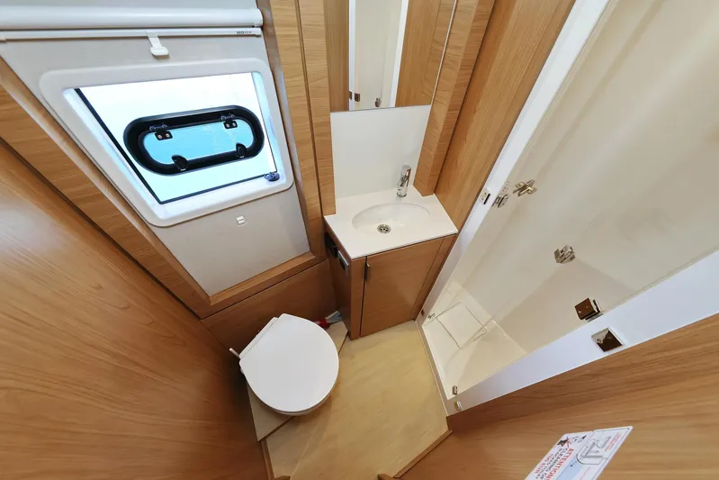 Breeze Yacht Photos Pics Compact bathroom in 2025 Bali 4.4 model, featuring toilet, sink, and shower.