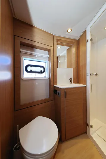 Breeze Yacht Photos Pics Modern bathroom interior in Bali 4.4 yacht, featuring wood accents and compact design, 2025 model.