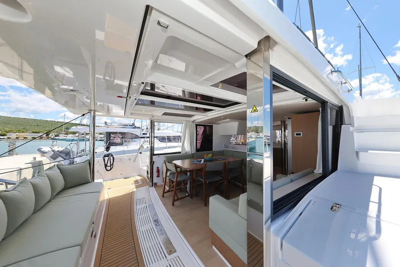 Breeze Yacht Photos Pics Luxurious Bali 4.4 yacht interior, featuring spacious seating and dining area, docked at marina.