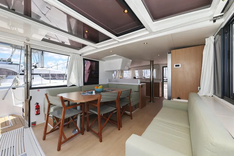 Breeze Yacht Photos Pics Luxurious interior of 2025 Bali 4.4 yacht with dining area and seating.