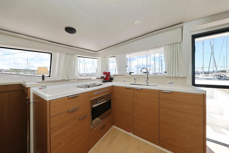 Breeze Yacht Photos Pics Modern kitchen interior on Bali 4.4 yacht, featuring wood cabinets and sleek appliances, 2025 model.