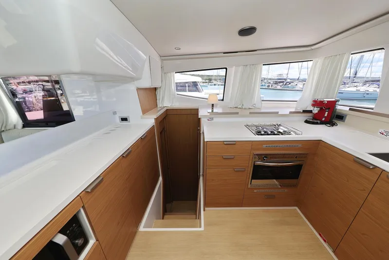 Breeze Yacht Photos Pics Modern kitchen interior on 2025 Bali 4.4 yacht, featuring wood cabinetry and sleek appliances.