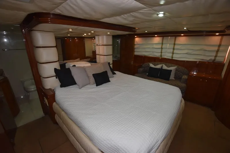 Big Hatt Yacht Photos Pics Luxurious bedroom interior of 1998 Hatteras 74 Sport Deck yacht with elegant furnishings.