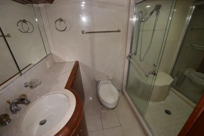 Big Hatt Yacht Photos Pics Luxurious bathroom on 1998 Hatteras 74 Sport Deck yacht with shower and vanity.