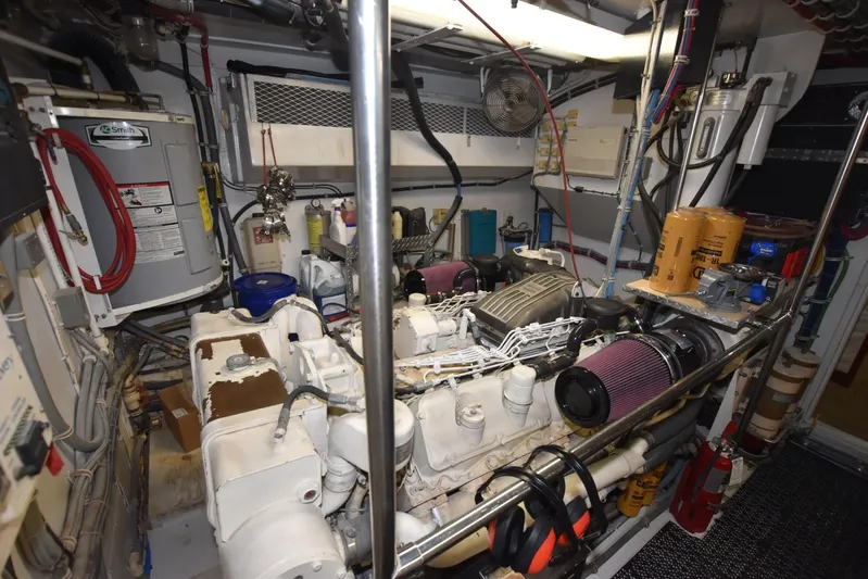 Big Hatt Yacht Photos Pics Engine room of 1998 Hatteras 74 Sport Deck yacht, featuring machinery and equipment.