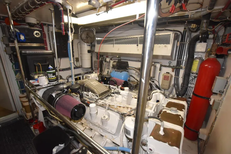 Big Hatt Yacht Photos Pics Engine room of 1998 Hatteras 74 Sport Deck yacht, featuring complex machinery and equipment.