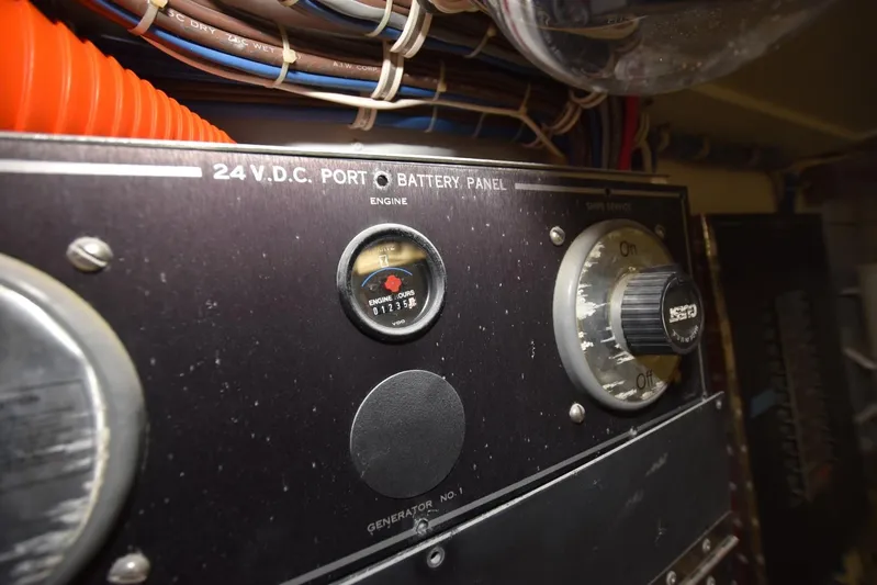 Big Hatt Yacht Photos Pics Control panel of a 1998 Hatteras 74 Sport Deck yacht, showing battery and engine gauges.