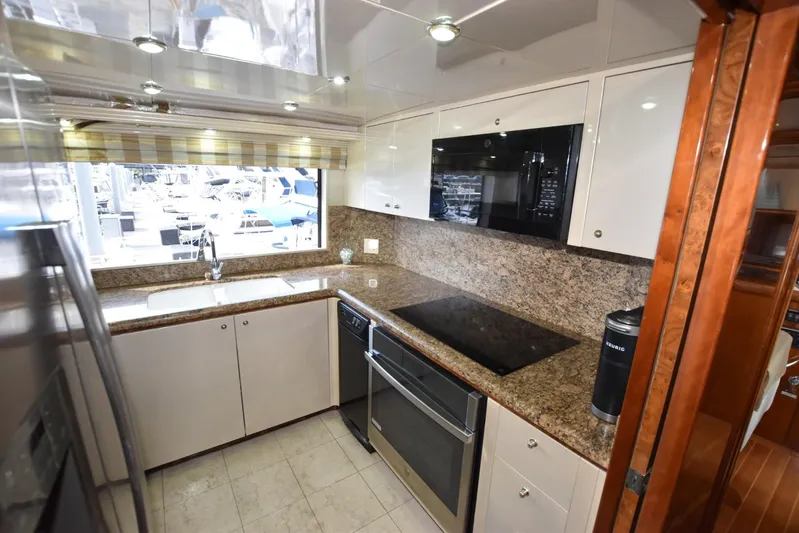 Big Hatt Yacht Photos Pics Modern kitchen in 1998 Hatteras 74 Sport Deck yacht with granite countertops and stainless steel appliances.