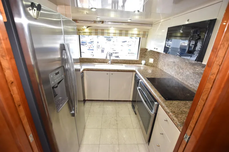 Big Hatt Yacht Photos Pics Luxurious kitchen in 1998 Hatteras 74 Sport Deck yacht with modern appliances and granite countertops.