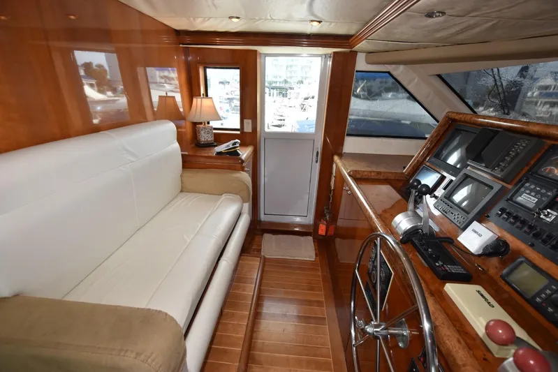 Big Hatt Yacht Photos Pics Luxurious helm of 1998 Hatteras 74 Sport Deck yacht with leather seating and advanced navigation controls.