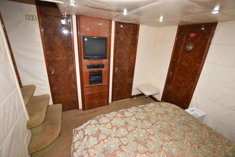 Big Hatt Yacht Photos Pics Luxurious cabin interior of 1998 Hatteras 74 Sport Deck yacht with TV and wood paneling.