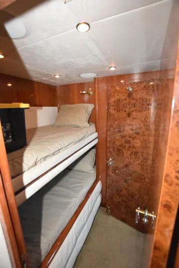Big Hatt Yacht Photos Pics Bunk beds in 1998 Hatteras 74 Sport Deck yacht cabin with wood paneling.