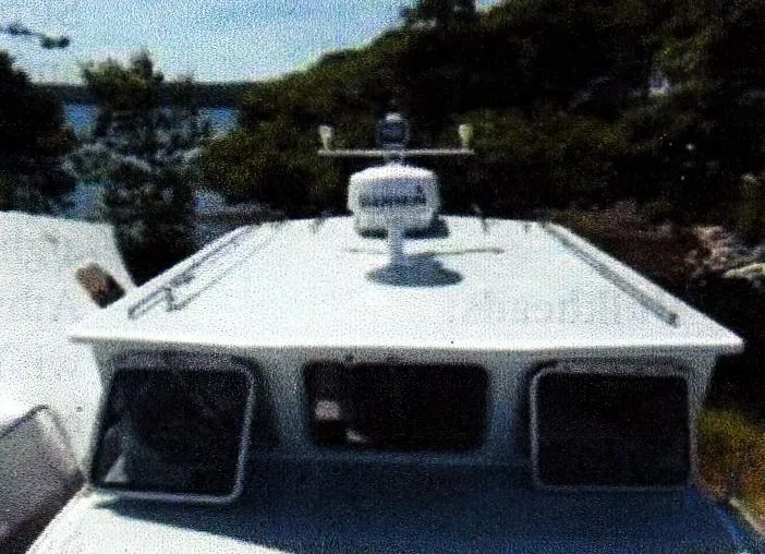 Janet Lynn Yacht Photos Pics Custom 1999 30 Novi Hardtop Cruiser with radar, docked near trees and water.