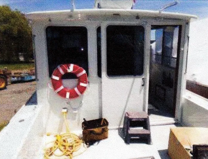 Janet Lynn Yacht Photos Pics 1999 Custom 30 Novi Hardtop Cruiser with life preserver and equipment on deck.
