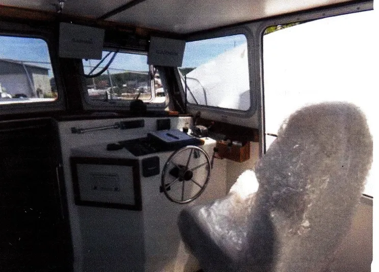 Janet Lynn Yacht Photos Pics Interior of 1999 Custom 30 Novi Hardtop Cruiser with steering wheel and wrapped seat.