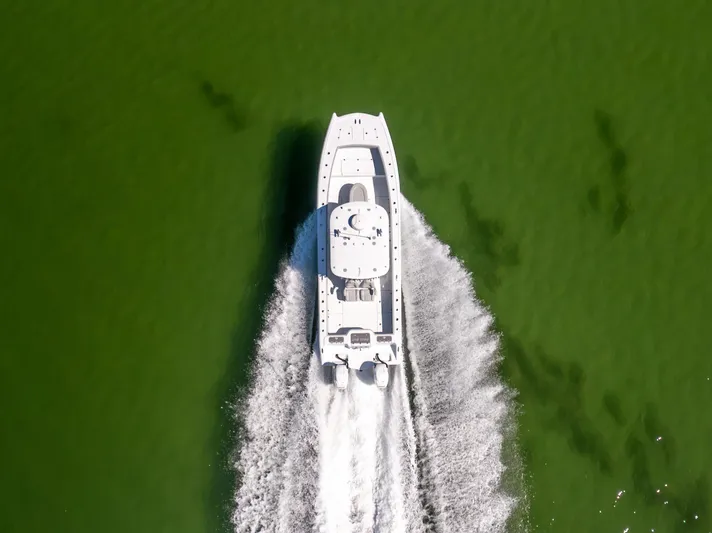  Yacht Photos Pics Aerial view of 2022 Freeman 34VH boat cruising on green water.