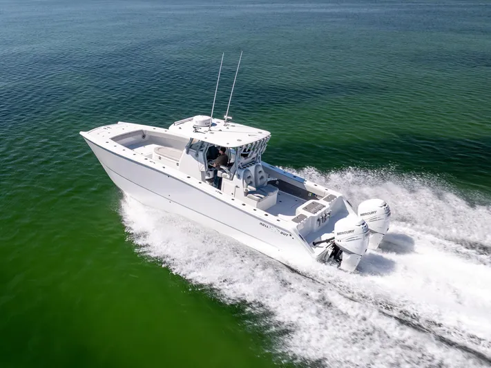  Yacht Photos Pics Freeman 34VH 2022 boat cruising on clear green water, showcasing powerful twin engines.