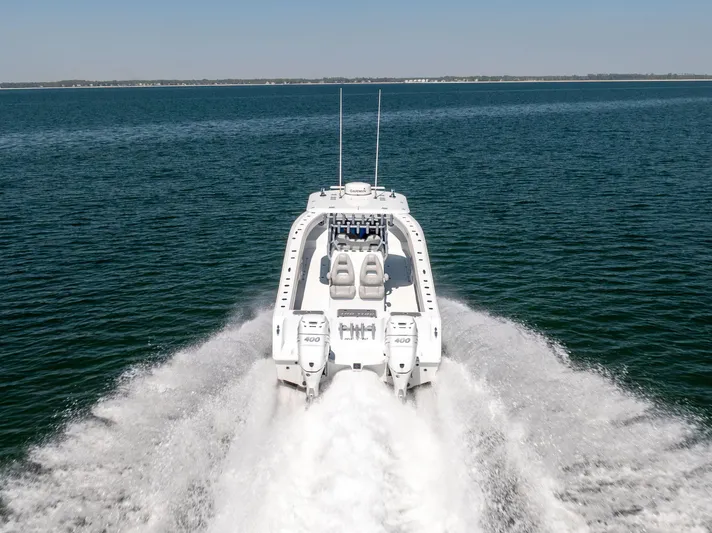  Yacht Photos Pics 2022 Freeman 34VH boat cruising on open water, rear view.