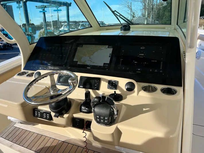  Yacht Photos Pics 2017 Scout 420 LXF boat dashboard with steering wheel and navigation screens.