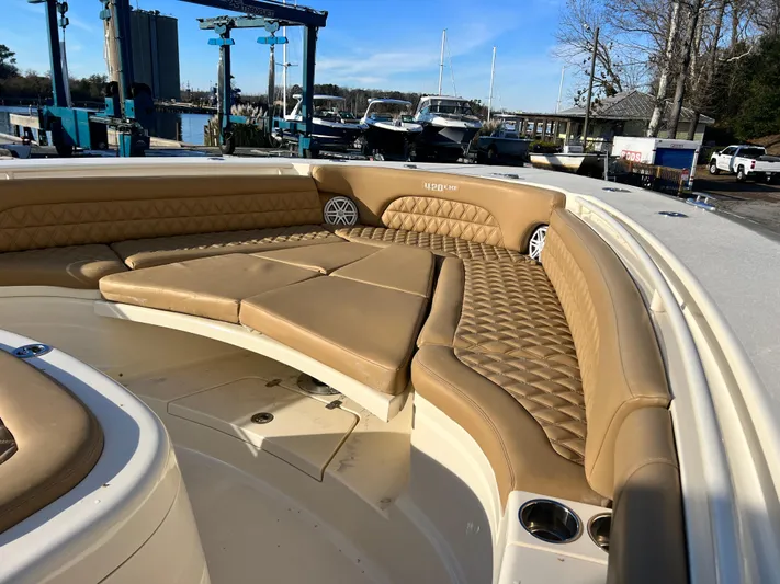  Yacht Photos Pics 2017 Scout 420 LXF boat with tan leather seating and cup holders, docked at a marina.