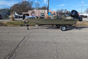 2026 Tracker Grizzly 1648 SC boat on trailer, parked outdoors near dealership.