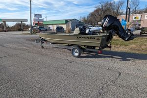 2026 Tracker Grizzly 1648 SC boat on trailer in parking lot.