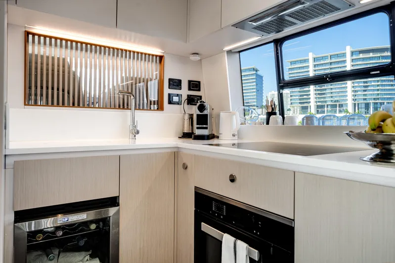 Spysea Yacht Photos Pics Modern kitchen interior of 2023 Azimut Fly 68 yacht with sleek design and appliances.