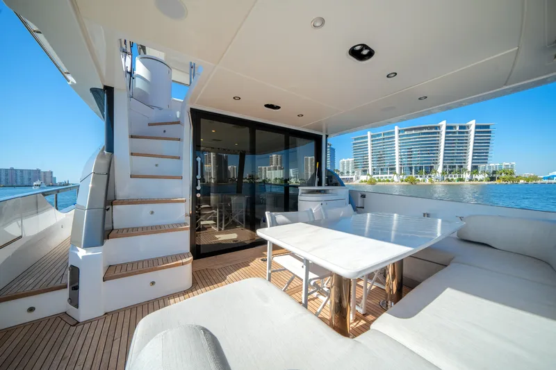 Spysea Yacht Photos Pics Luxurious 2023 Azimut Fly 68 yacht deck with seating, table, and waterfront view.