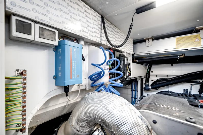 Spysea Yacht Photos Pics Engine room of 2023 Azimut Fly 68 yacht, showcasing electrical components and wiring.