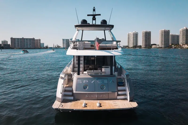 Spysea Yacht Photos Pics 2023 Azimut Fly 68 yacht on water with city skyline backdrop.