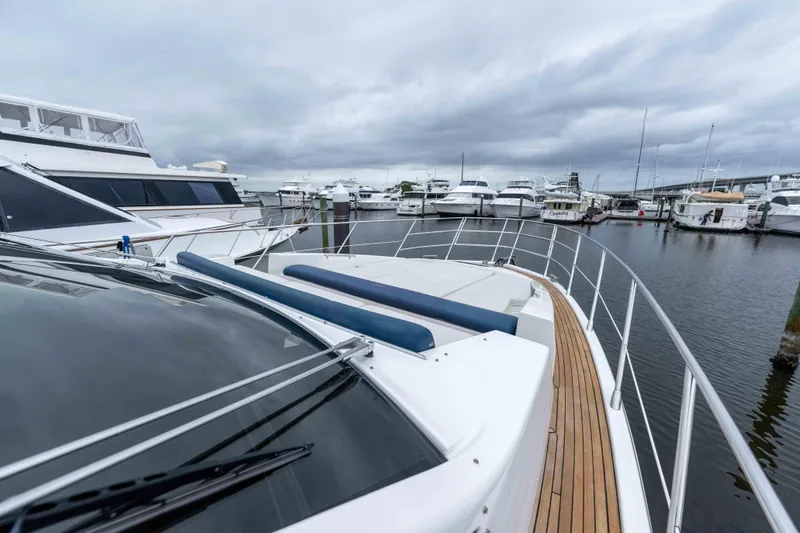 Treasure X Yacht Photos Pics 2015 Azimut 55S yacht docked in a marina with cloudy skies.