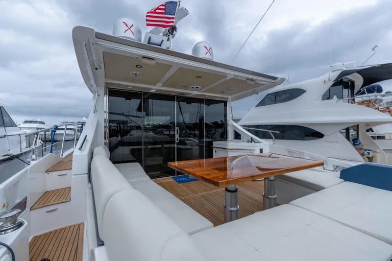 Treasure X Yacht Photos Pics Luxurious 2015 Azimut 55S yacht with elegant deck and seating area, docked at marina.