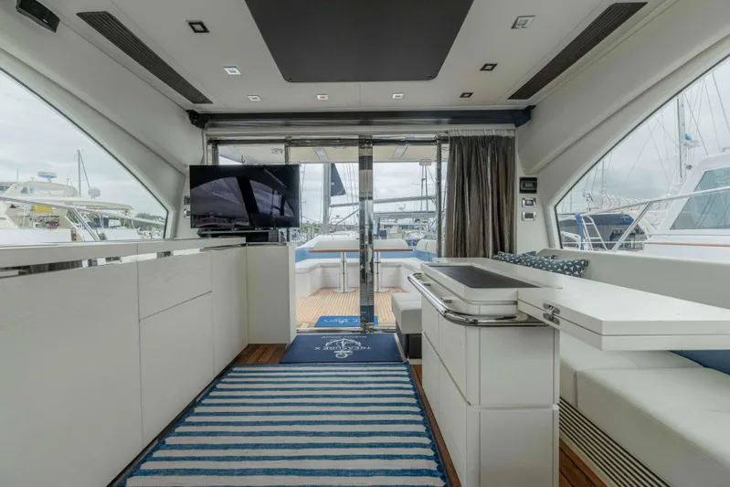 Treasure X Yacht Photos Pics Luxurious interior of a 2015 Azimut 55S yacht with modern furnishings and marina view.