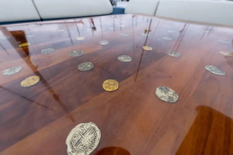 Treasure X Yacht Photos Pics Luxurious Azimut 55S 2015 yacht table with embedded decorative coins.