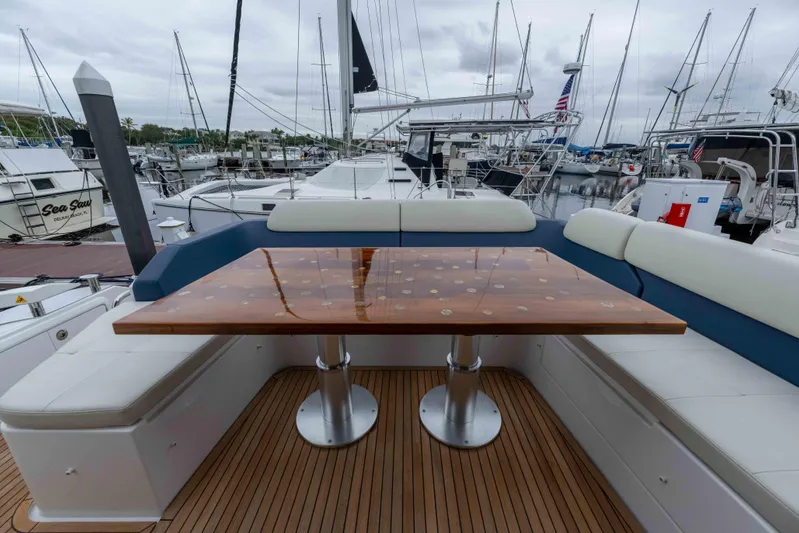 Treasure X Yacht Photos Pics 2015 Azimut 55S yacht deck with elegant wooden table and cushioned seating.