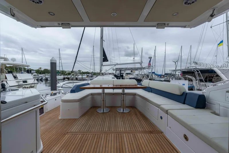 Treasure X Yacht Photos Pics Luxurious 2015 Azimut 55S yacht deck with seating and table, docked at marina.