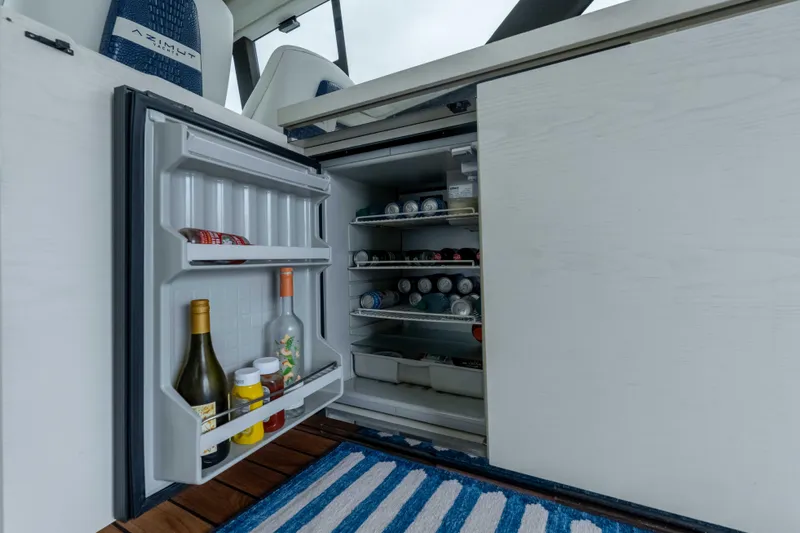 Treasure X Yacht Photos Pics Open fridge on 2015 Azimut 55S yacht, stocked with beverages and condiments.
