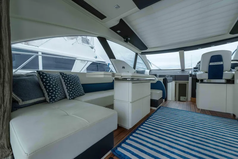 Treasure X Yacht Photos Pics Luxurious interior of a 2015 Azimut 55S yacht with modern seating and striped rug.