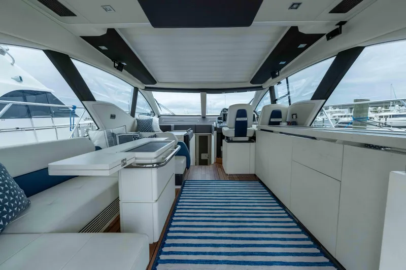 Treasure X Yacht Photos Pics Luxurious interior of a 2015 Azimut 55S yacht with modern seating and striped rug.