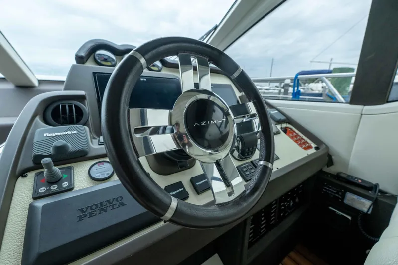 Treasure X Yacht Photos Pics 2015 Azimut 55S yacht helm with steering wheel and control panel.
