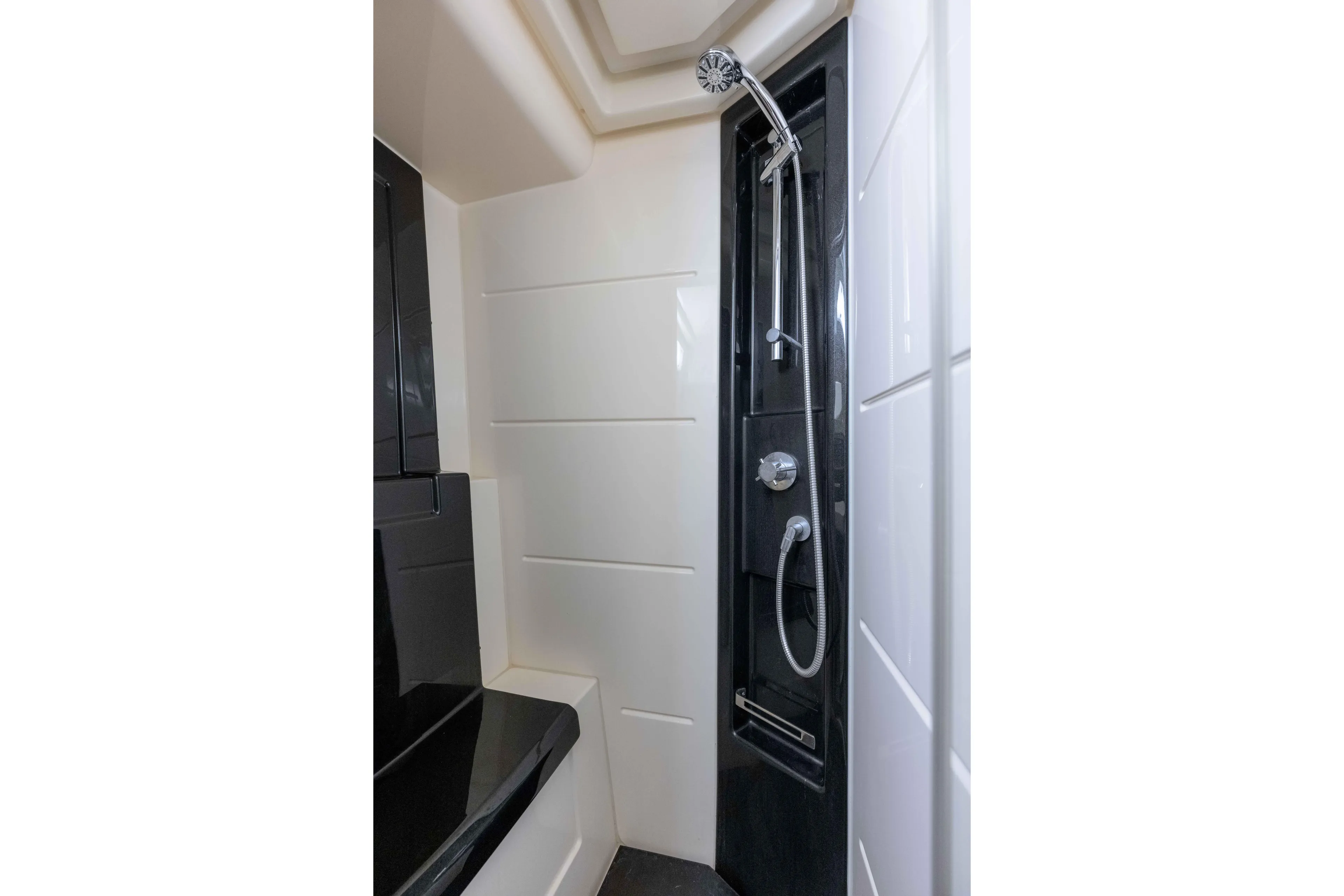 Treasure X Yacht Photos Pics Luxurious shower area in 2015 Azimut 55S yacht, featuring sleek black and white design.